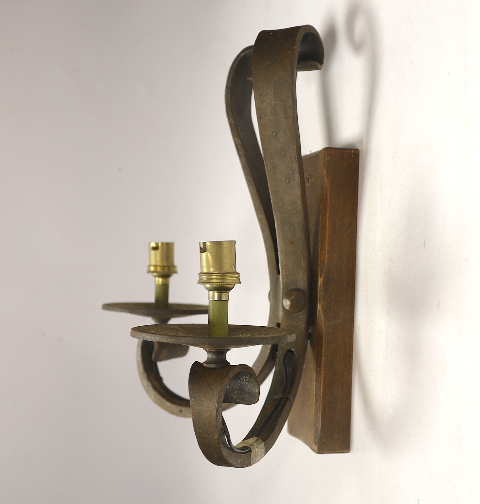 A pair of wrought iron two branch wall lights, height 33cm